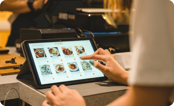 close up of someone ordering food through a touch screen tablet