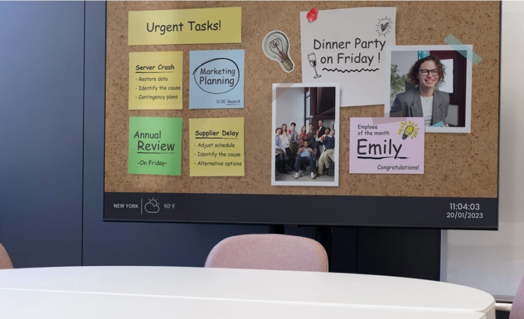 A table with a digital bulletin board behind