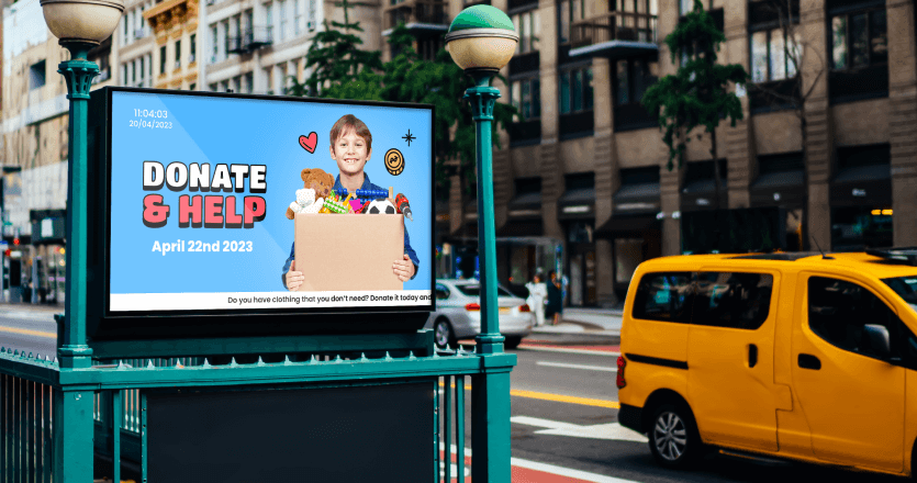 A digital signage screen in the city promoting a charity