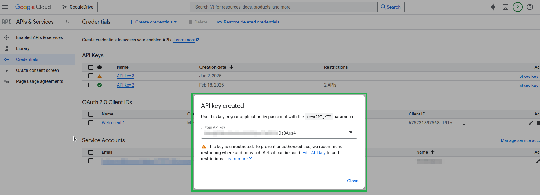 "Google Cloud notification displaying the details of a newly created API key and a warning about restricting its usage."