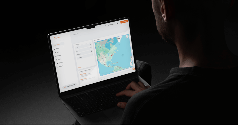 Person using a laptop displaying a map and dashboard interface