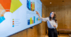 Woman giving a presentation using a digital screen with charts