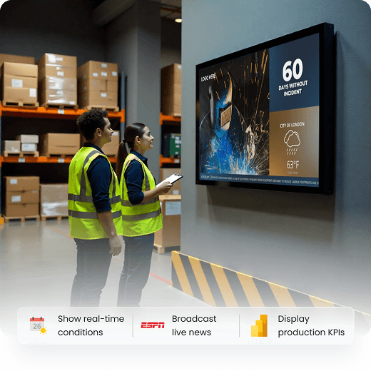 Warehouse workers viewing digital signage with Yodeck branding